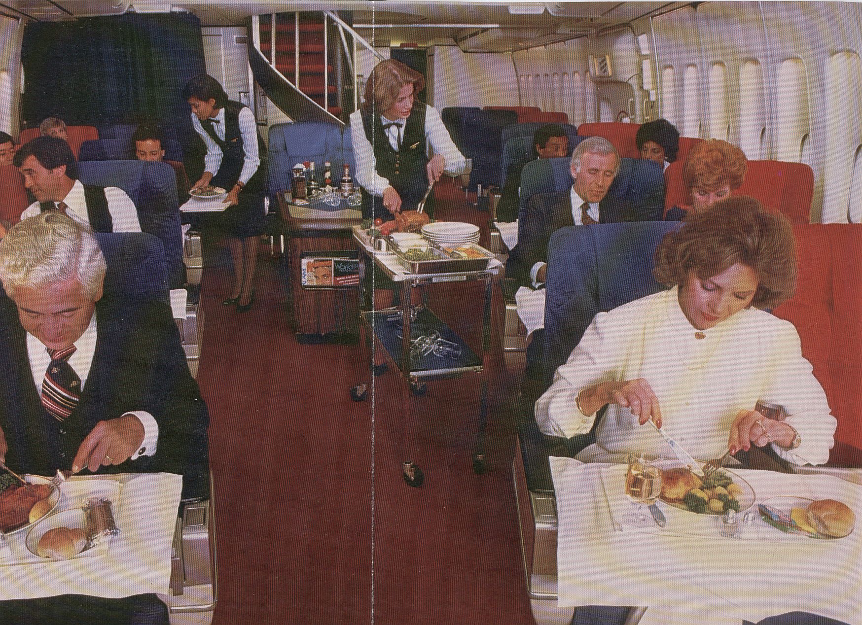 1983 A Boeing 747 First Class cabin during an elaborate meal service that included a roast cart at the customer's seat.